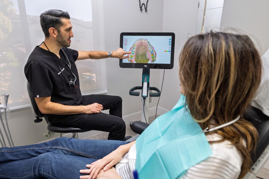Reviewing a 3D digital scan with a patient at DNA Dental Studio